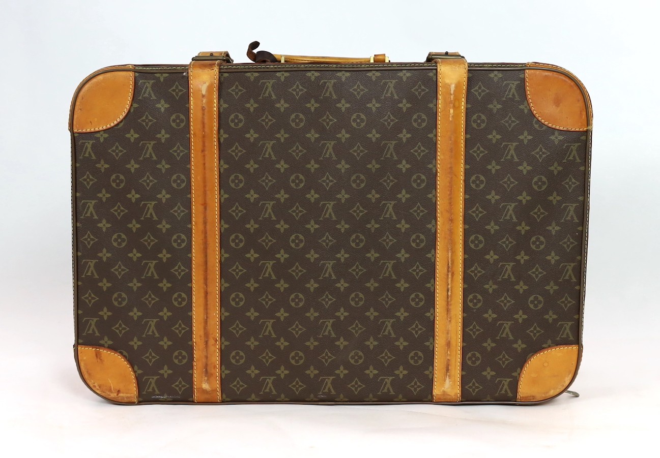 A 1980/90s Louis Vuitton canvas monogram suitcase, 59cm wide, 46cm deep, 23cm high